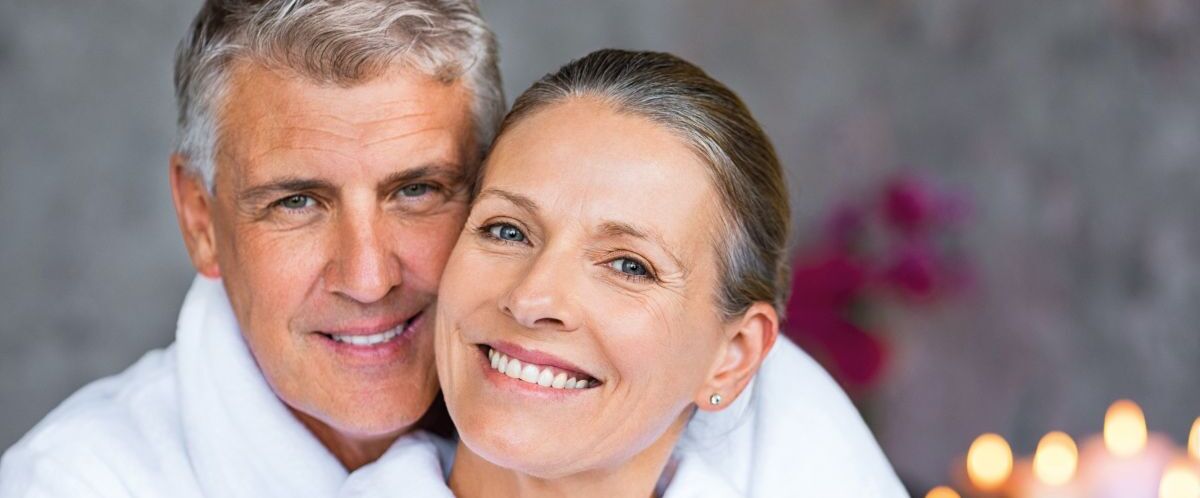 Mature couple in bathrobe at spa