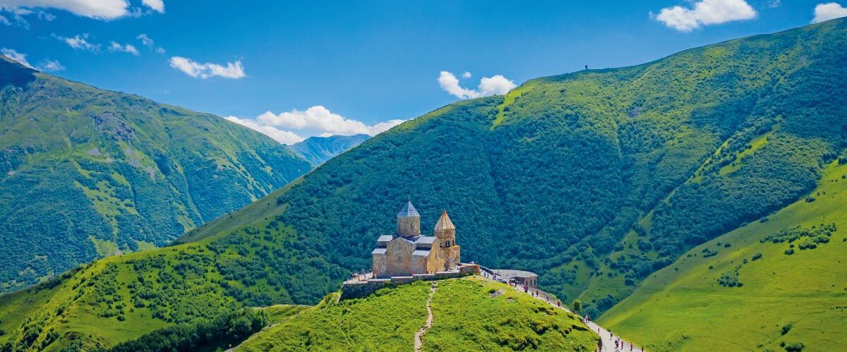 Gergeti Trinity Church against Caucasus mountains in Georgia